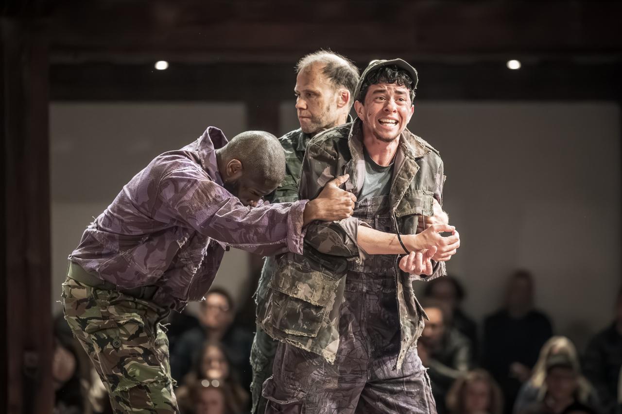 Trieve-Blackwood-Cambridge-as-Sargeant-Simon-Scardifield-as-Sargeant-and-Vinnie-Heaven-as-Eilif-in-Mother-Courage-and-Her-Children-at-Shakespeares-Globe-c.-Marc-Brenner Trieve-Blackwood-Cambridge-as-Sargeant-Simon-Scardifield-as-Sargeant-and-Vinnie-Heaven-as-Eilif-in-Mother-Courage-and-Her-Children-at-Shakespeares-Globe-c.-Marc-Brenner