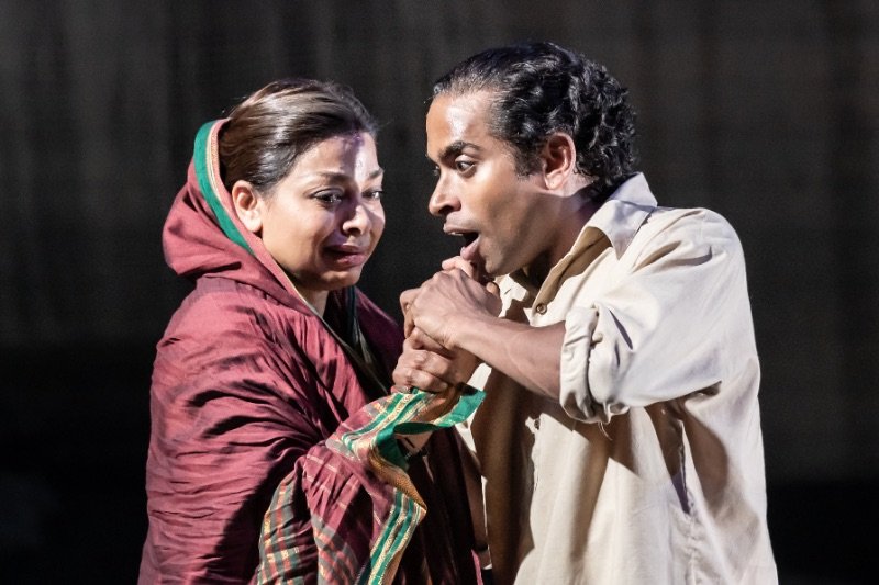 Hiran-Abeysekera-Nathuram-Godse-and-Ayesha-Dharker-Aai-in-The-Father-and-the-Assassin-at-the-National-Theatre-2023.-Credits-Marc-Brenner Hiran-Abeysekera-Nathuram-Godse-and-Ayesha-Dharker-Aai-in-The-Father-and-the-Assassin-at-the-National-Theatre-2023.-Credits-Marc-Brenner