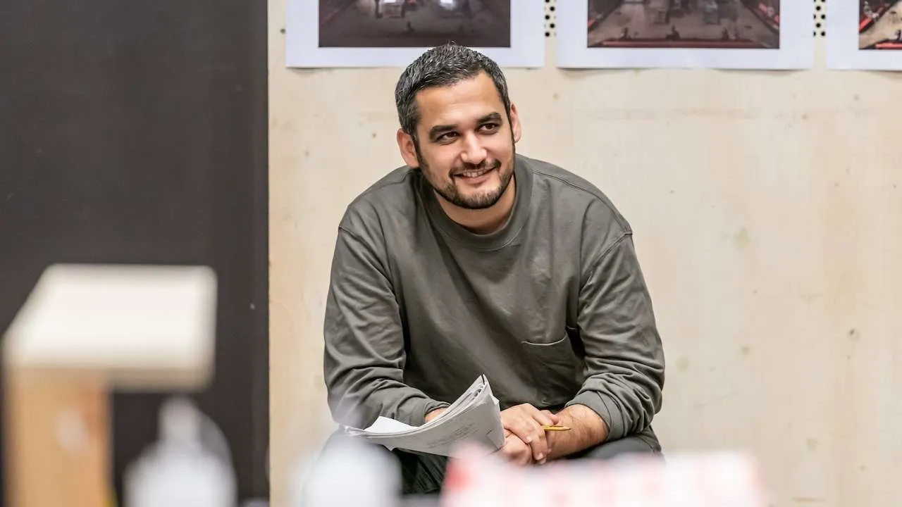 Man sitting holding a script