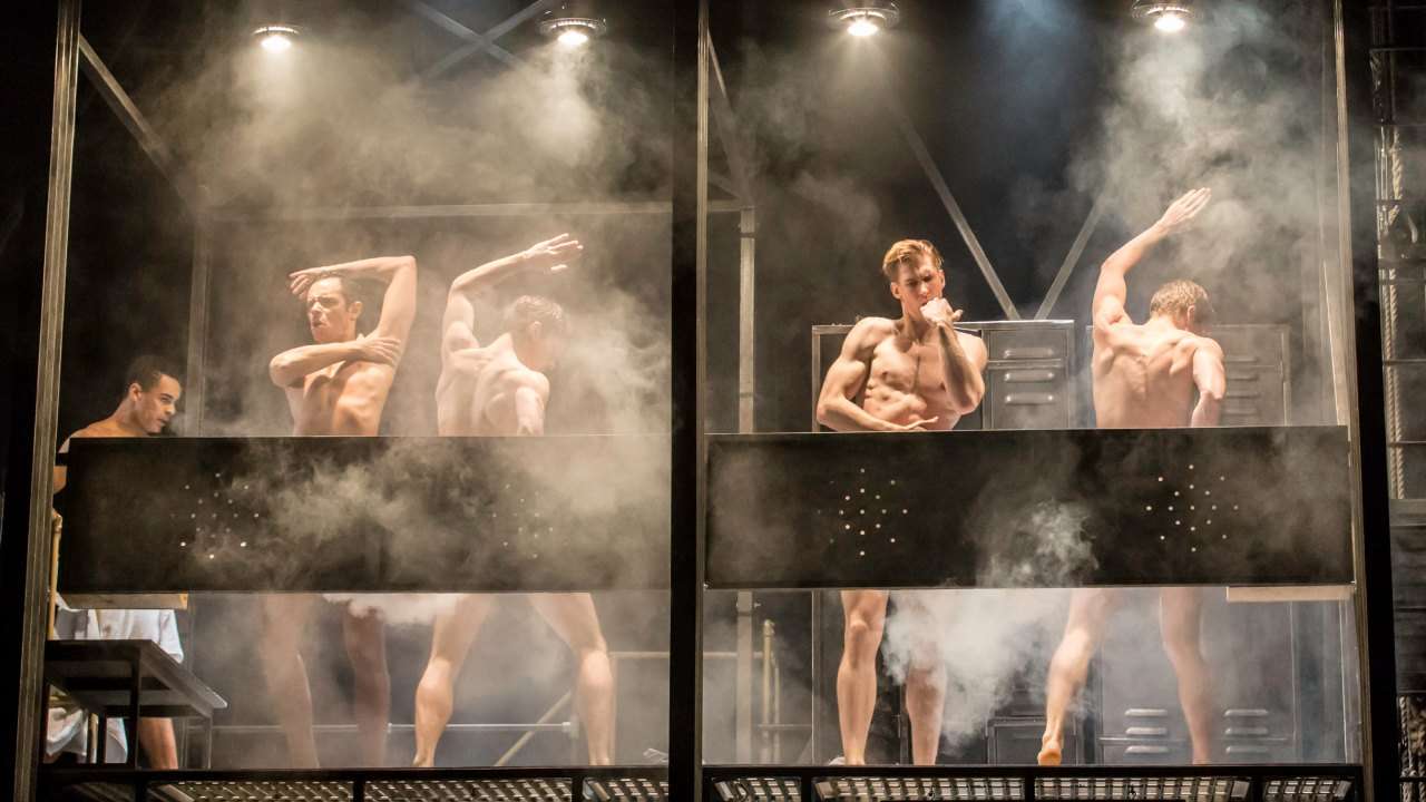 Actors on stage showering. Matthew Bourne's THE CAR MAN. Photo by Johan Persson