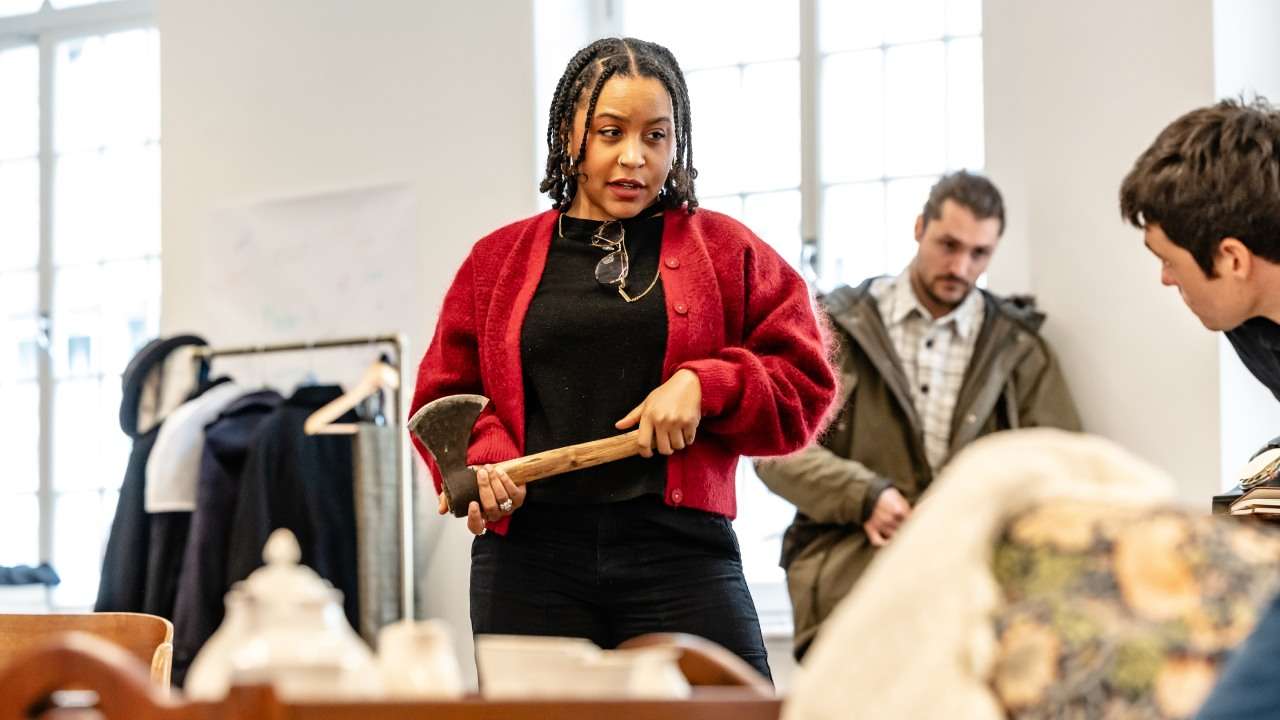 Director Ola Ince holding an axe in rehearsal for The Mousetrap in London