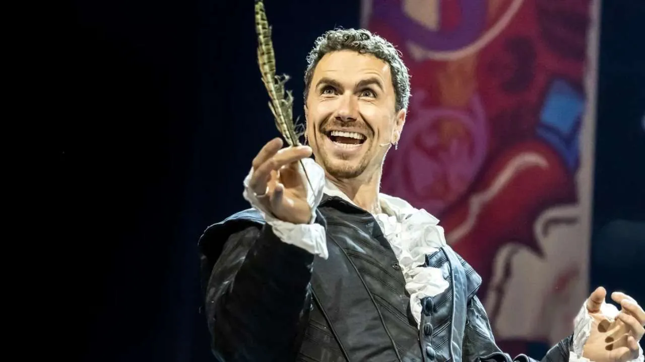 Richard Fleeshman as Shakespeare holding a quill in Something Rotten! in Concert.
