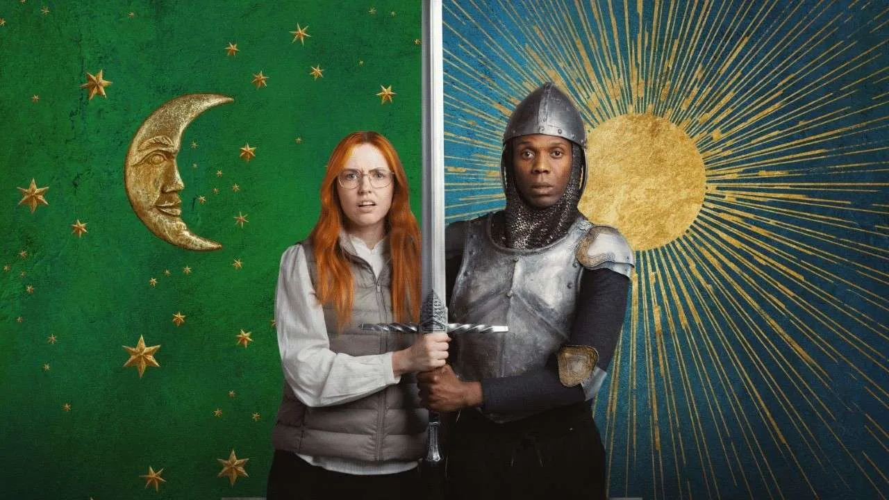 Two cosplayers hold a sword between them, standing in front of green moon-and-star and blue sun murals.