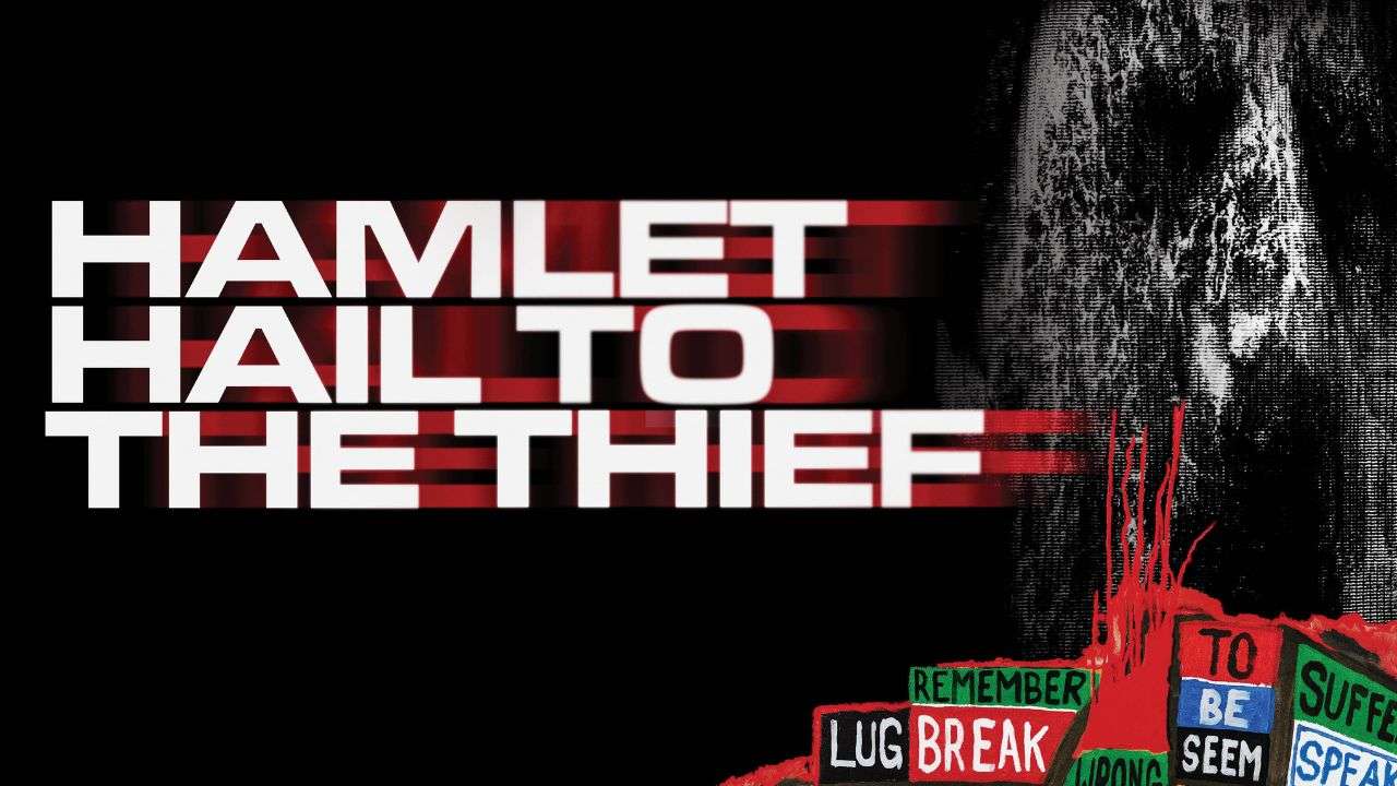 Promotional poster: 'HAMLET HAIL TO THE THIEF' in bold white on black, with a grayscale portrait on the right and colorful protest signs at the bottom right.