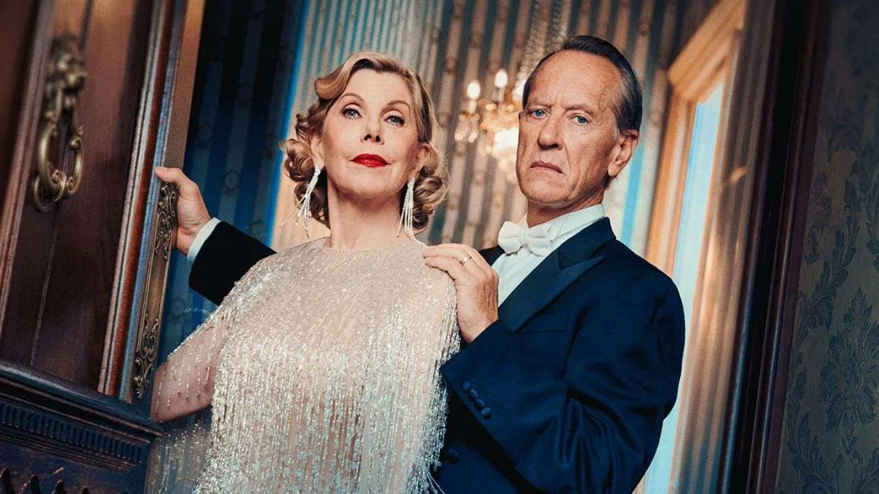 Elegant older couple posing in a vintage ballroom, woman in a sparkling beaded gown and man in a tuxedo with a white bow tie.