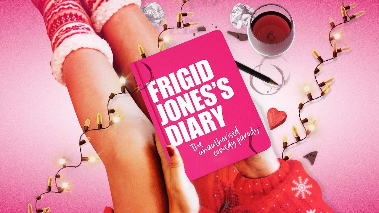 Pink book cover reads Frigid Jones’s Diary, held between legs on a pink holiday background with string lights and a wine glass nearby.
