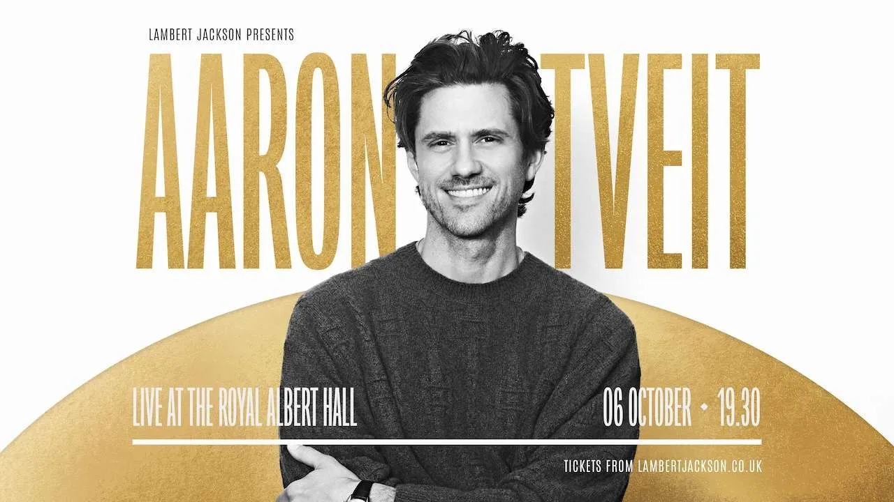 Promotional poster for Aaron Veit: smiling man in a gray sweater with a gold backdrop and live show details at Royal Albert Hall.