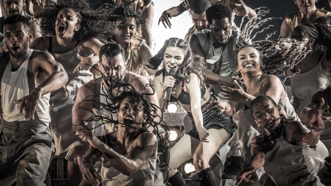 Rachel Zegler as Eva Peron, and the cast of Evita. Photo by Marc Brenner.