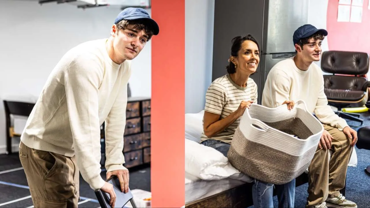 Left image: Noah Schnapp in rehearsal for Affluenza, leaning over a chair in a rehearsal room with taped-out floor markings. Right image: Janette Manrara and Noah Schnapp in rehearsal for Affluenza, sitting on a bed and smiling while holding a woven laundry basket.