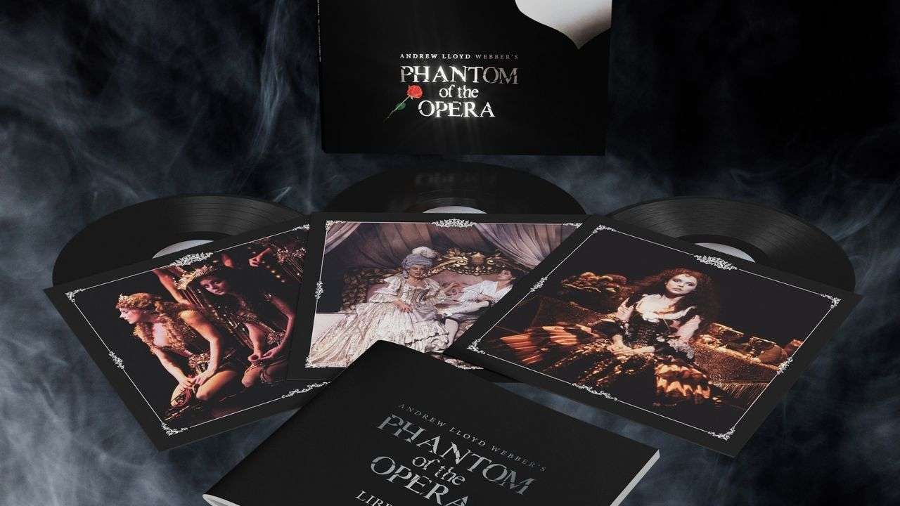 Box set of The Phantom of the Opera with vinyl records and ornate illustrated booklets displayed on a dark, smoky background.