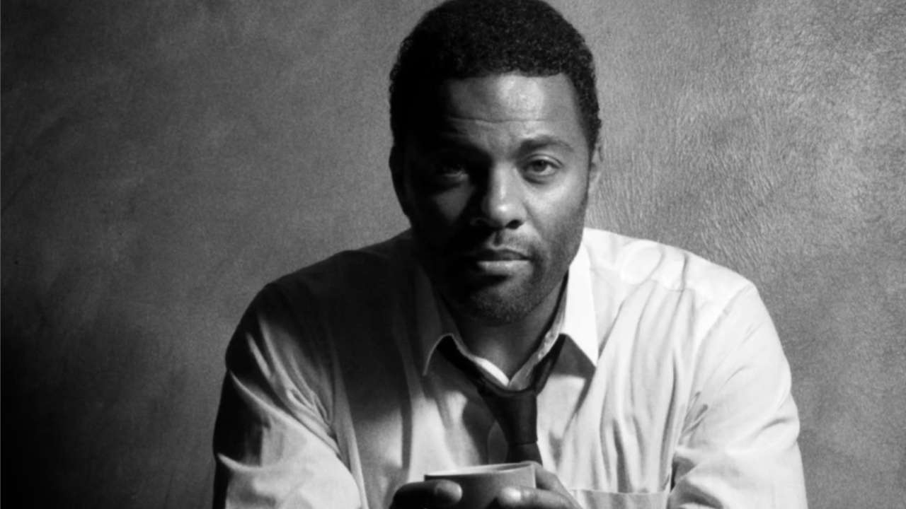 Headshot of Ray Fearon holding a cup between his hands